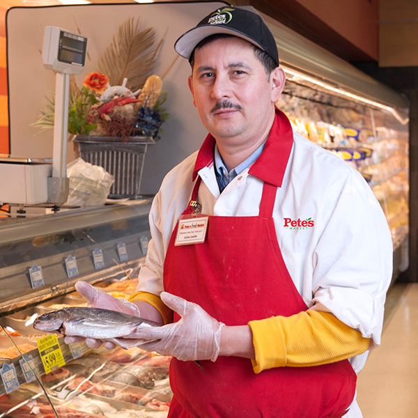 Pete's Employee Holding Fish